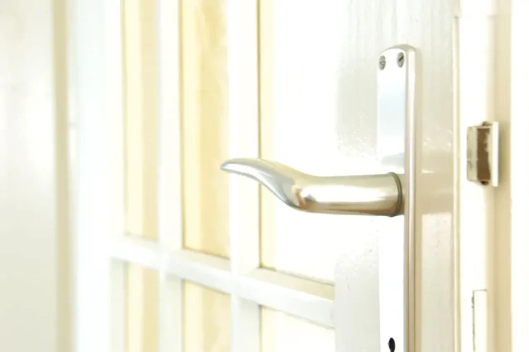 How to change a uPVC door lock in Castleford – white door with a lever handle on a long backplate, Locksmith Castleford guide to barrel, handle and multipoint replacement