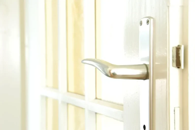 Lock repair or replacement in Castleford – white door with a lever handle and locking plate, Locksmith Castleford guide to which your door needs