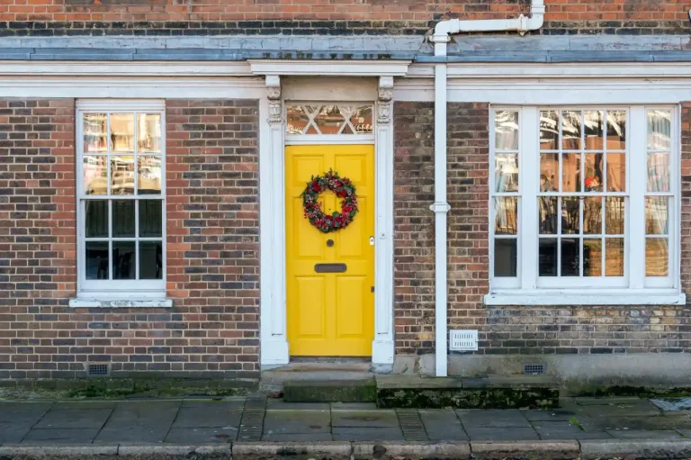 Types of door locks in the UK – yellow front door on a red-brick Victorian house in Castleford, Locksmith Castleford guide to identifying your lock